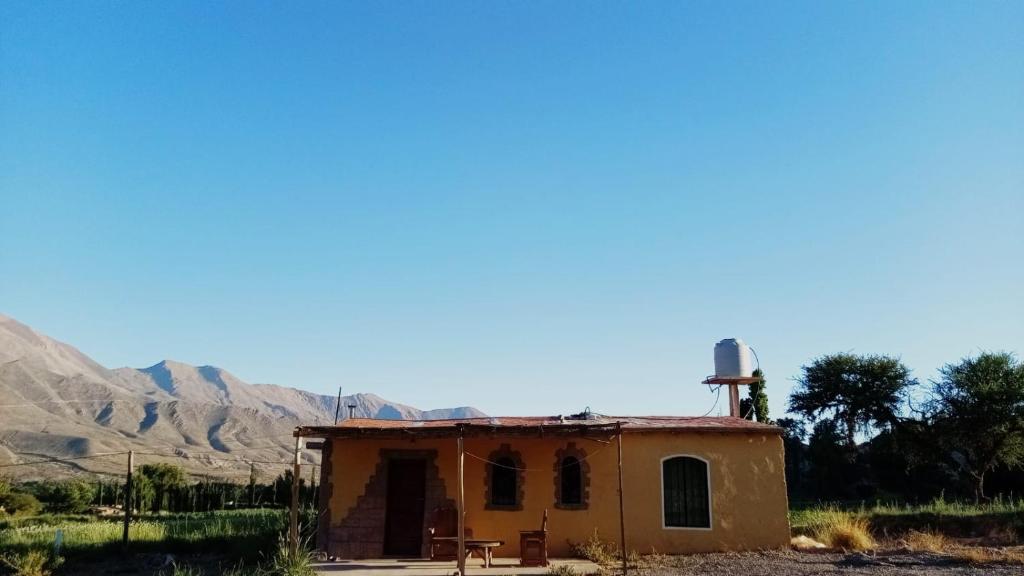 an old building in the middle of the desert at Nativas Cabaña Amarilla in Senador Pérez
