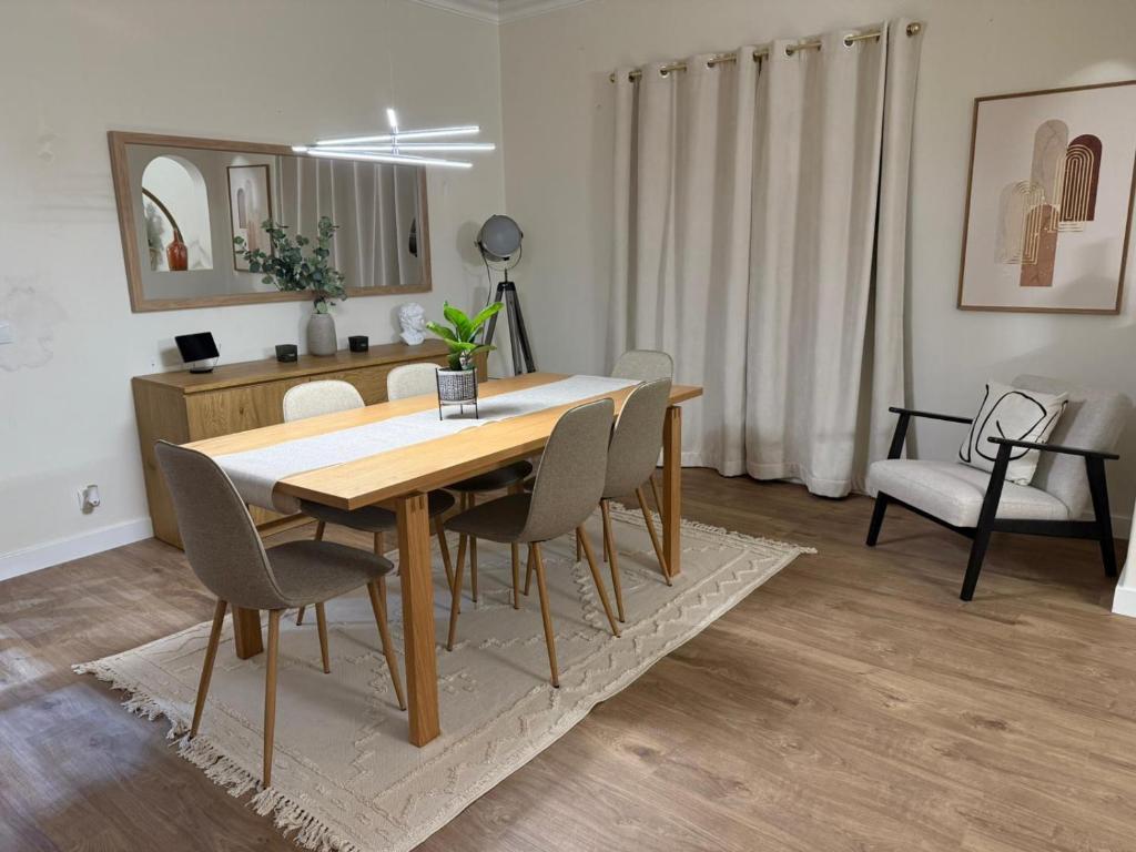 een eettafel en stoelen in de woonkamer bij The quinta in Quinta do Conde