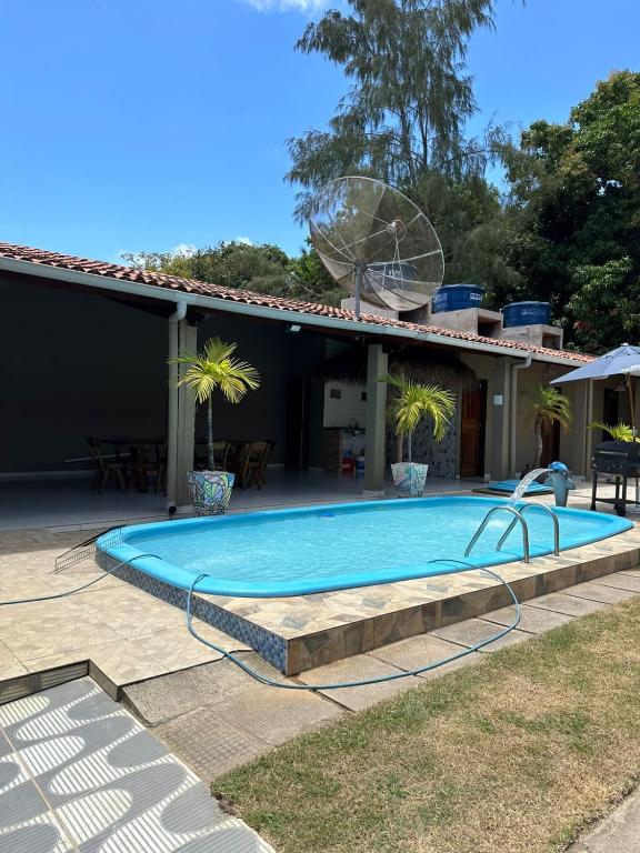 a swimming pool in front of a house at Casa Aiyra in São Miguel dos Milagres