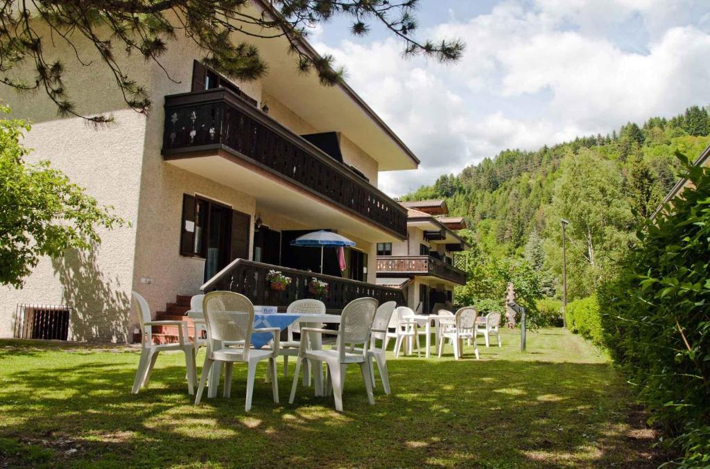 a table and chairs in front of a building at Apartments in Pieve di Ledro - Ledrosee 22645 in Ledro