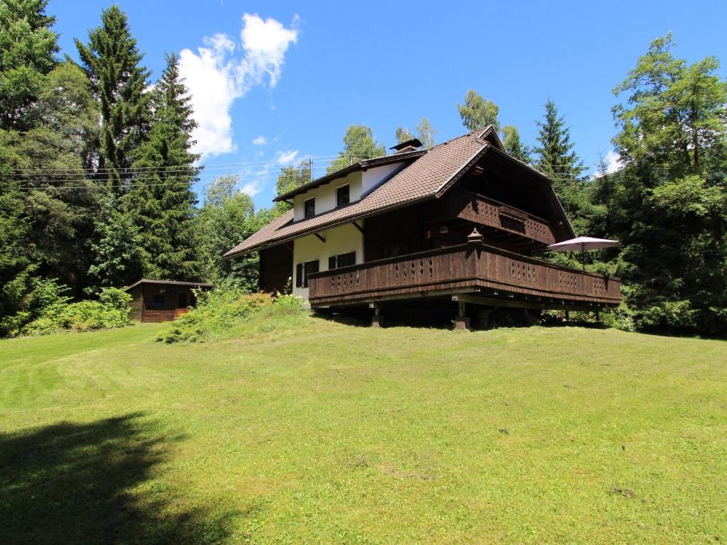 a house sitting on top of a green field at Mooshausl in Gnesau