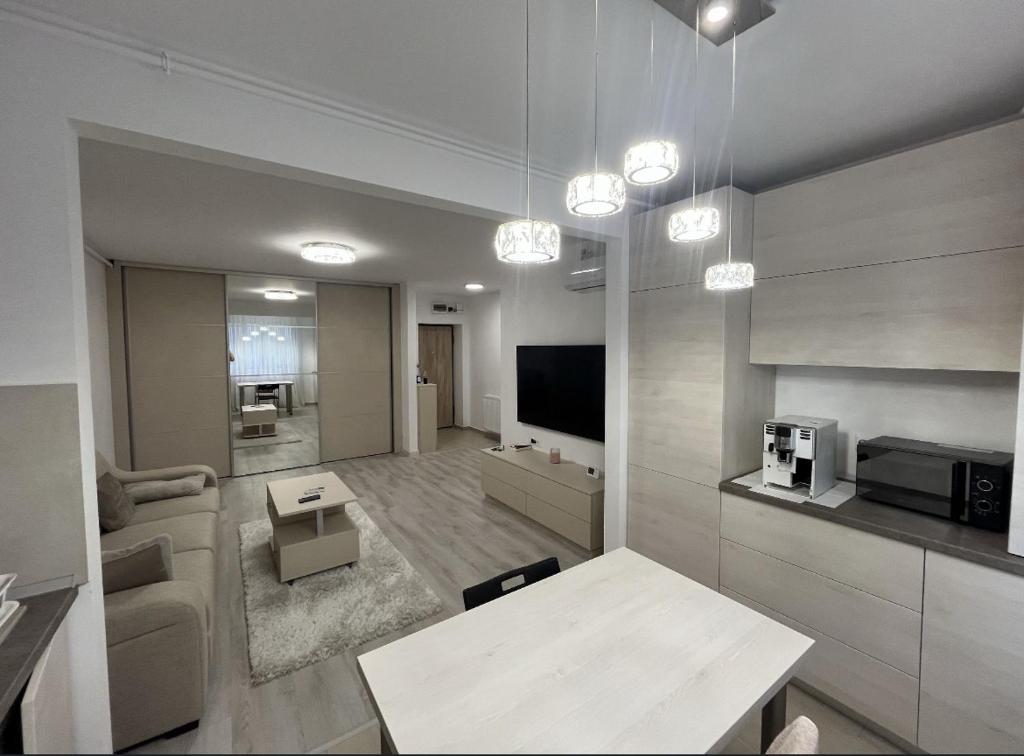 a living room with a couch and a table and a tv at Hills pallady in Bucharest