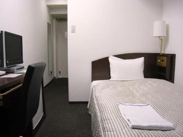 Una habitación de Tachikawa Urban Hotel