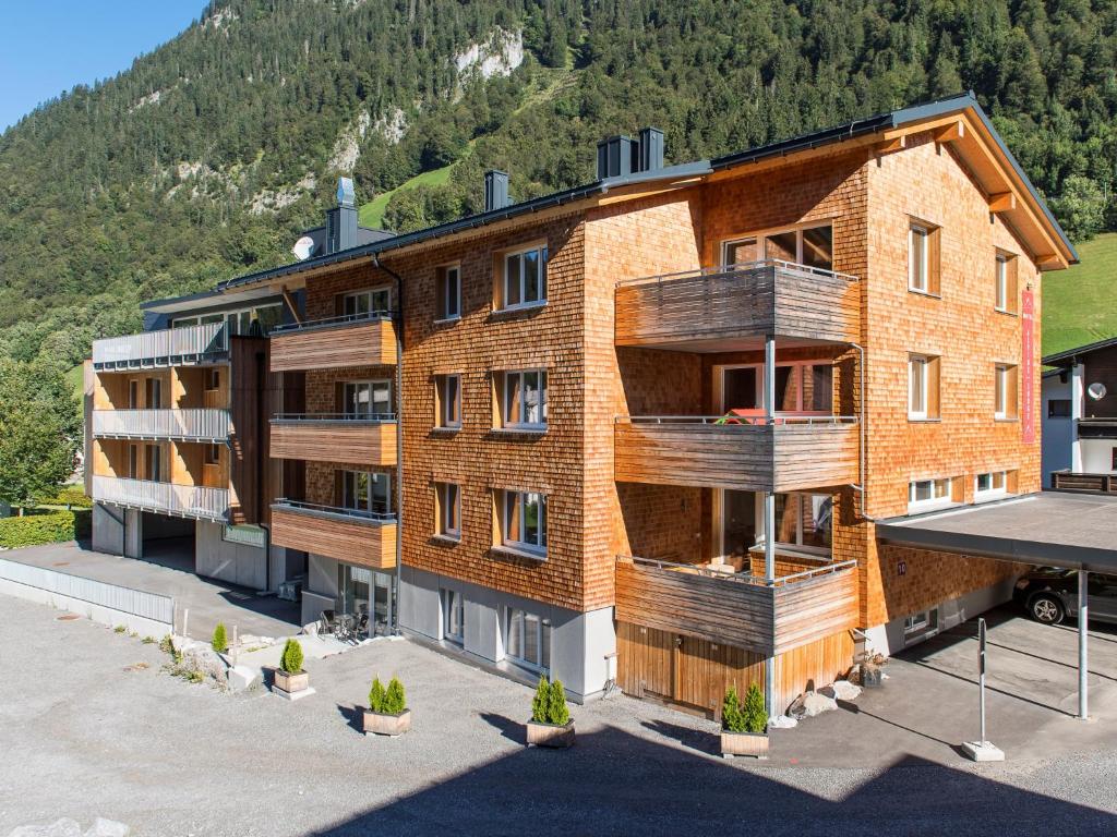 an apartment building with balconies on the side of it at Alpine Lodge Klösterle am Arlberg in Klösterle