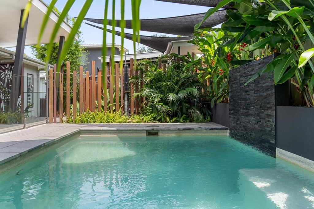 a swimming pool in front of a house at Summit to Sea, Elevated Luxury in Coolum Beach