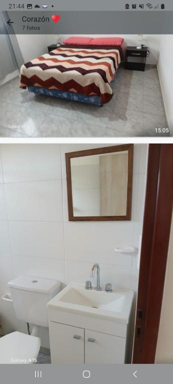 a bathroom with a sink and a bed with a mirror at Saavedra 3 in Viedma