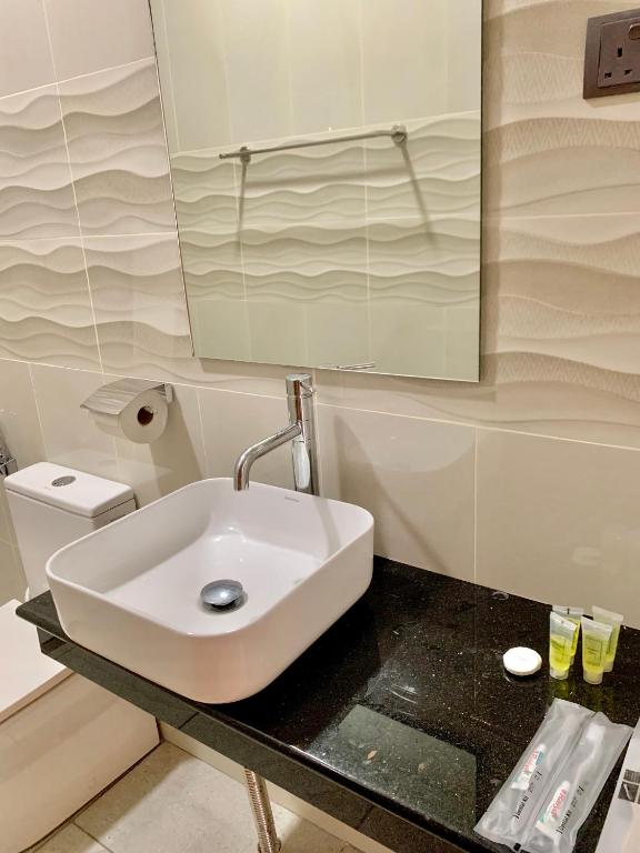 a bathroom with a sink and a mirror at Single Room 2 Bed in Papar