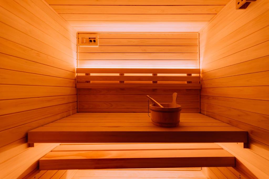 a wooden sauna with a bucket in the middle at One Harajuku: Private Oasis in Tokyo