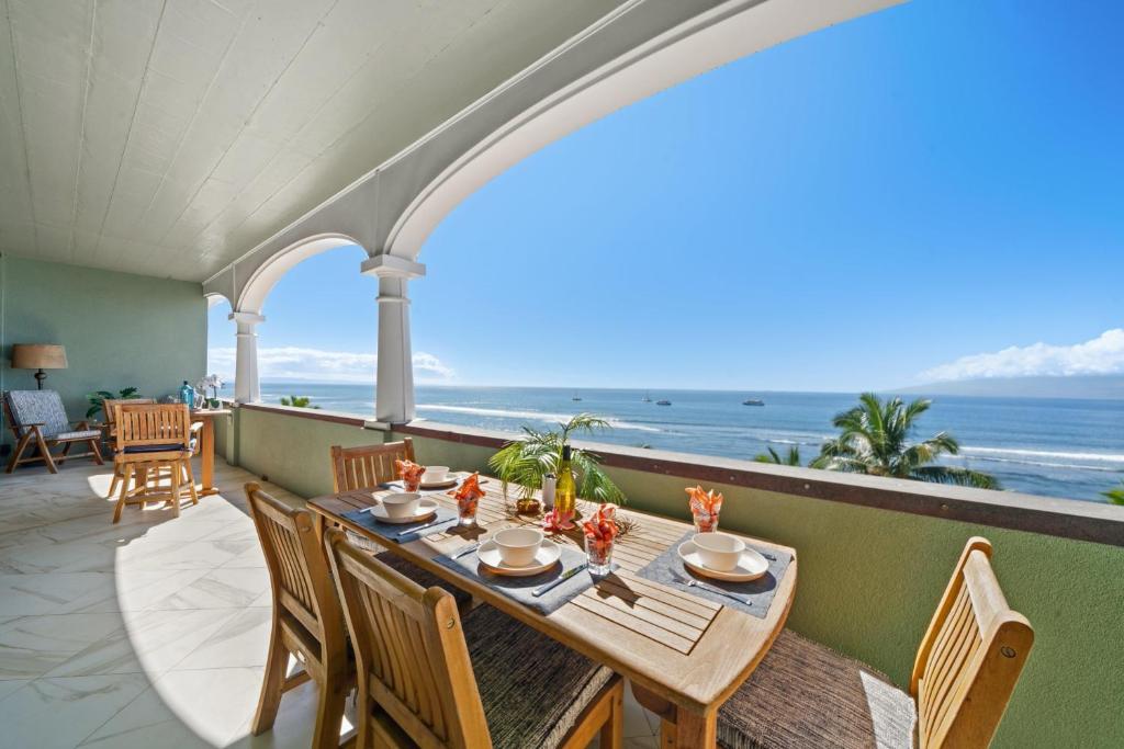 een eettafel op het balkon met uitzicht op de oceaan bij Lahaina Shores PH3 in Wainee