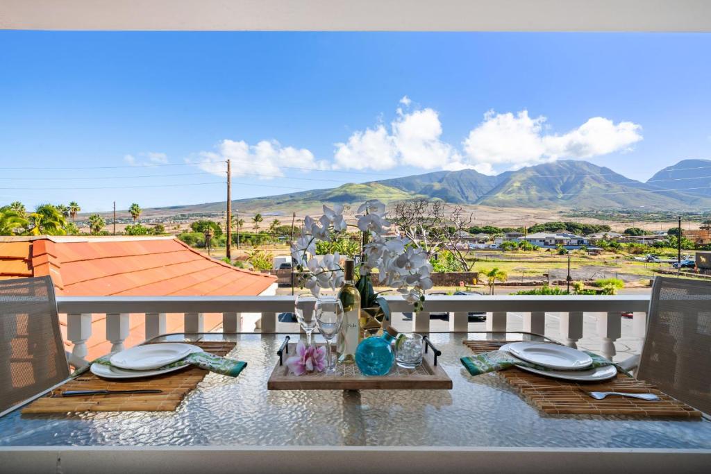 a table on a balcony with a view of mountains at Lahaina Shores 212 in Lahaina