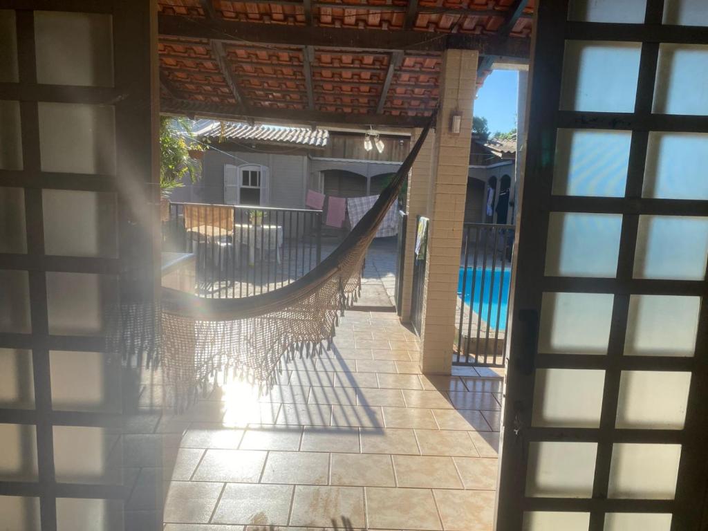 an outside view of a porch with a hammock at Med House in Guaíra