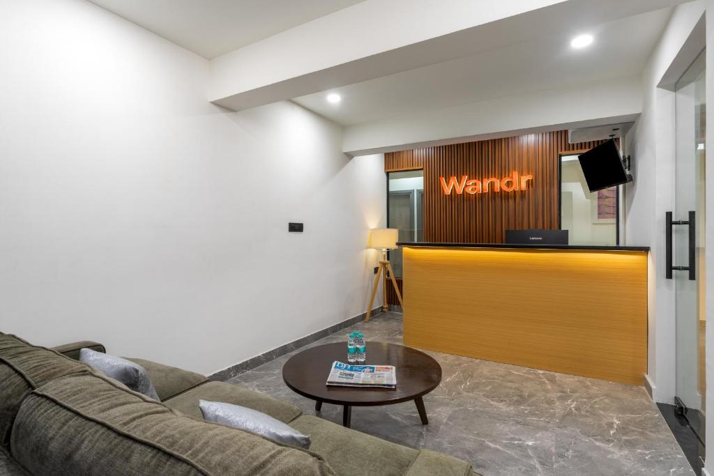 un soggiorno con un divano e una sala d'attesa di Wandr Hotel Richmond Road a Bangalore