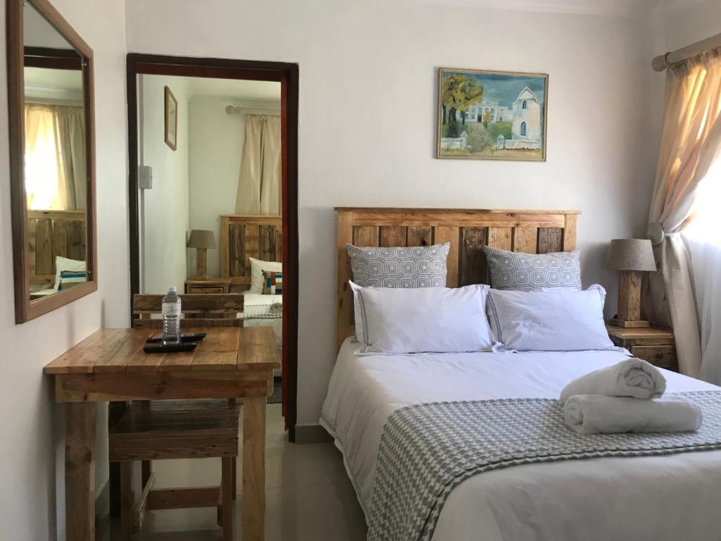 En eller flere senge i et værelse på MELJAA GROUP Guesthouse