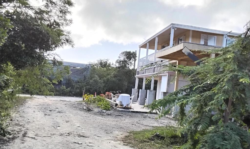 a house on the side of a dirt road at Claudette Guest House in Michelson