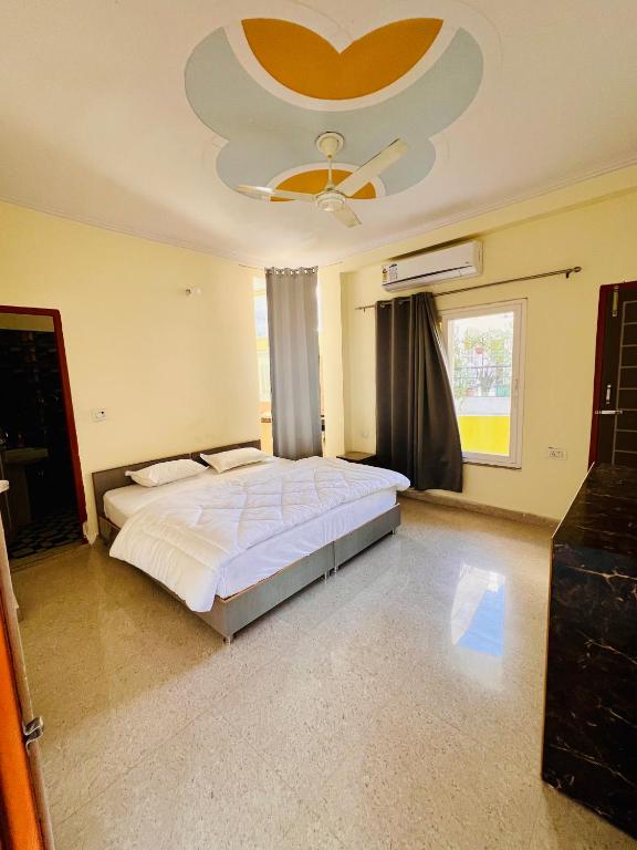 a bedroom with a large bed with a ceiling at Vedic Hatha Vinyasa Yoga Ashram in Narendranagar