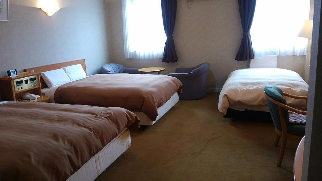 Postel nebo postele na pokoji v ubytování Hotel Hitachi Hills
