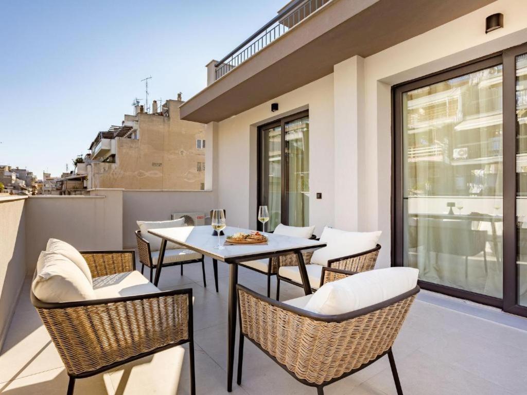 a patio with a table and chairs on a balcony at Ptolemeon 20, Apts & Studios Thessaloniki Center in Thessaloniki