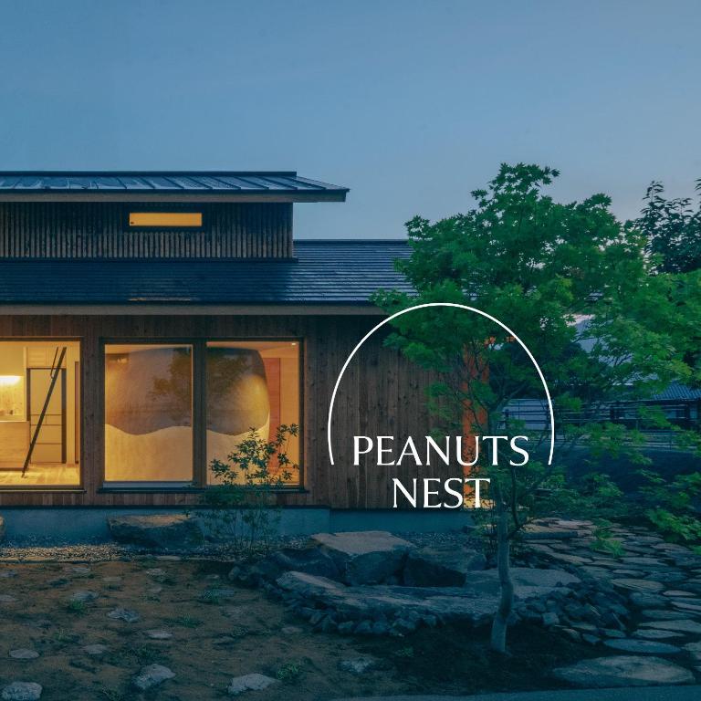 a house with a sign that reads peanuts nest at Peanuts Nest in Nagano