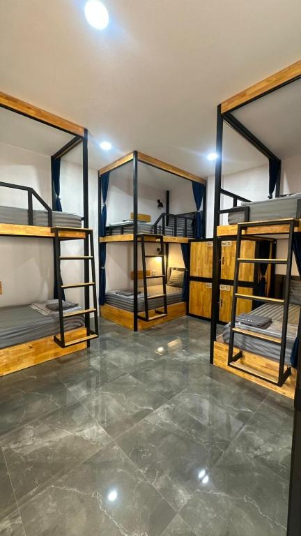 a room with three bunk beds in it at Cosy Hostel in Ko Tao
