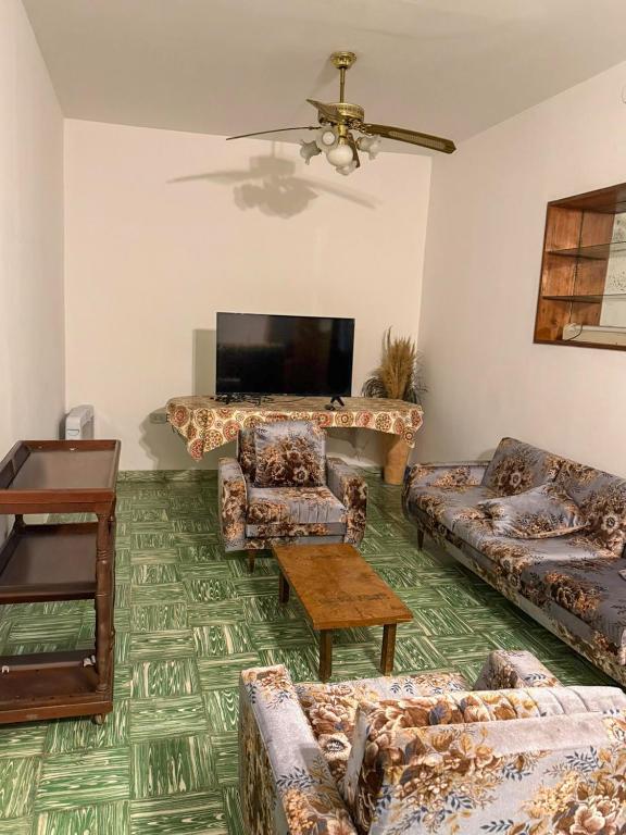 a living room with couches and a flat screen tv at CASA HORTENSIA in Salta