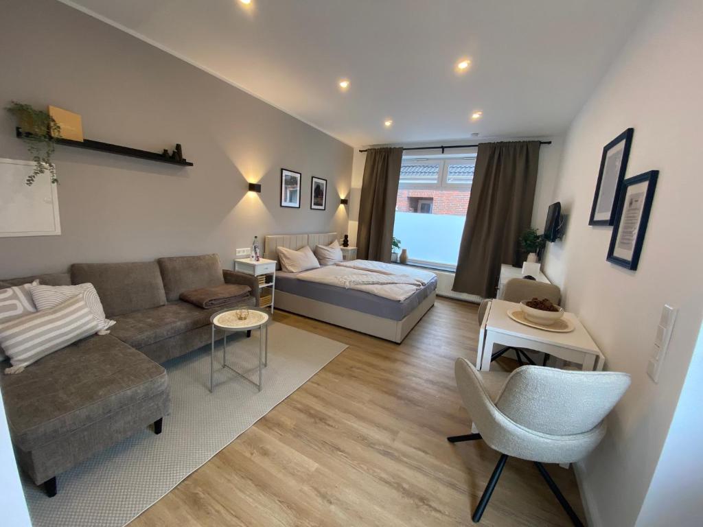 a large living room with a couch and a bed at Petkumer Deichkoje in Emden