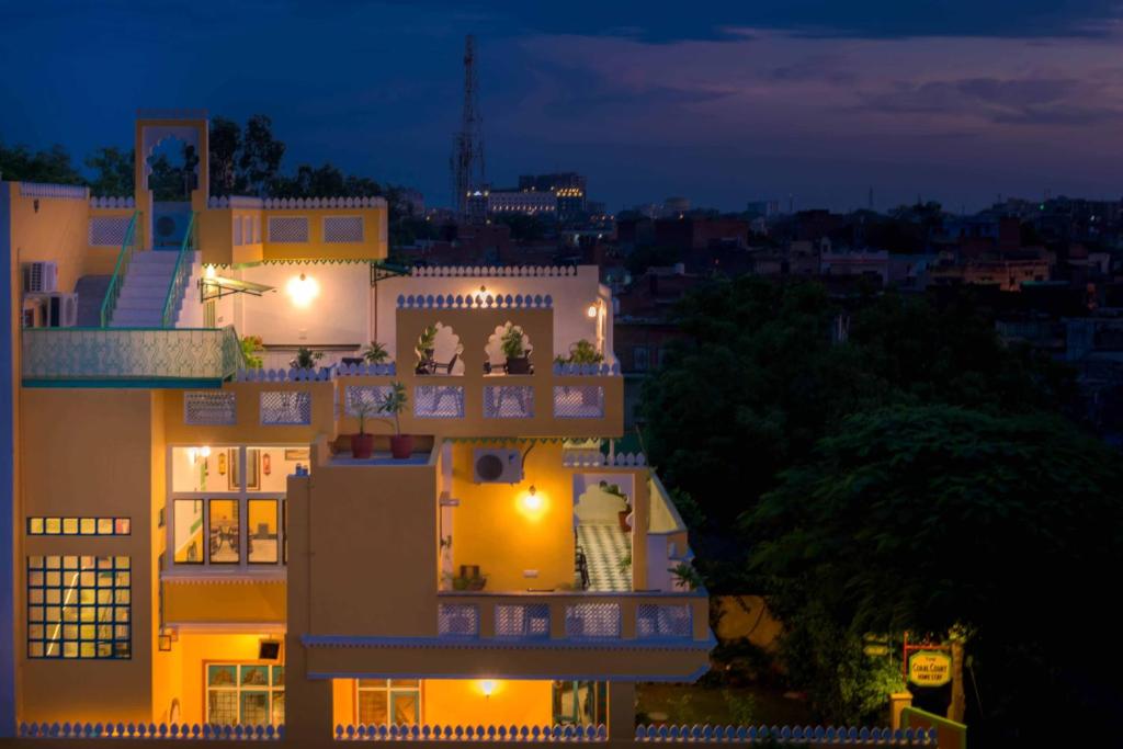 a night view of a building with lights at The Coral Court Homestay in Agra