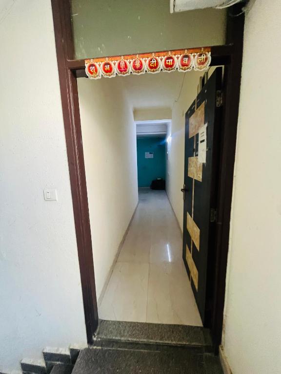 a hallway in an office building with a door with lights on it at Hotel Lal in Jāmb
