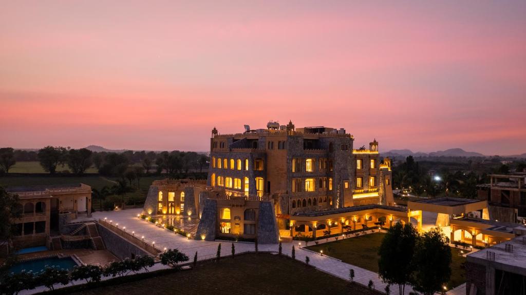 a building at night with the lights on at Raj Leela Heritage Resort By Estherea in Jāmb