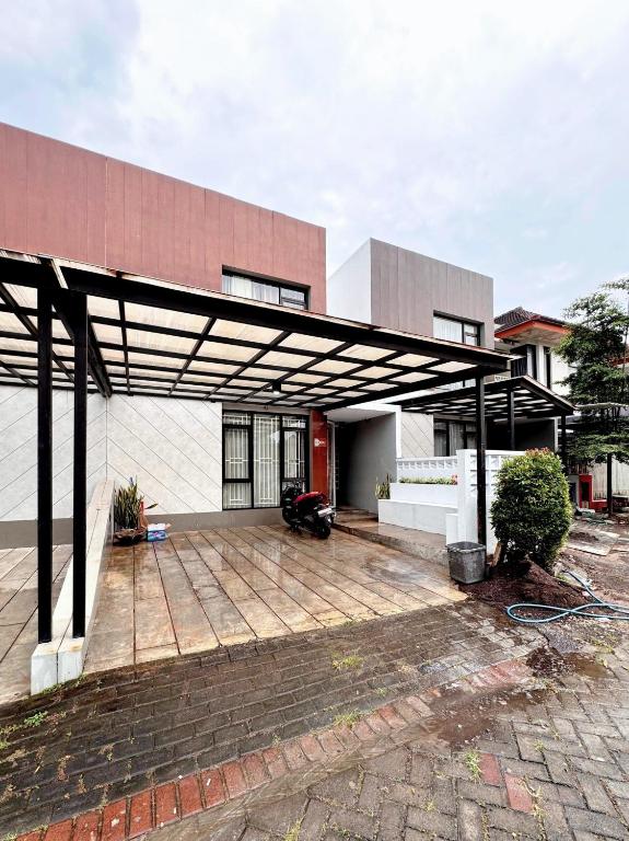 a large pergola in front of a building at Villa FiFa in Blimbing
