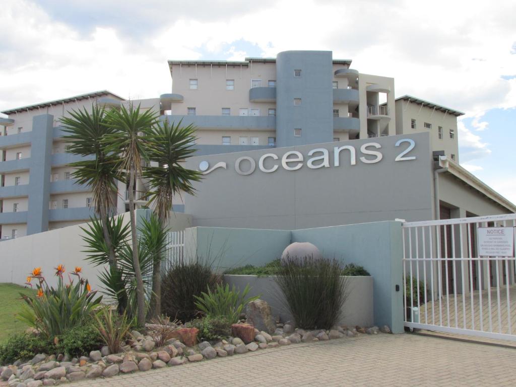 a building with a sign that reads oceans at Point Village Accommodation - Ocean Two 12 in Mossel Bay