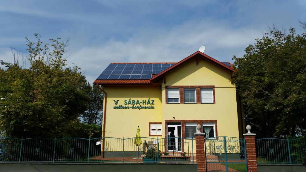 a house with solar panels on the roof at Sába-Ház in Balatonboglár