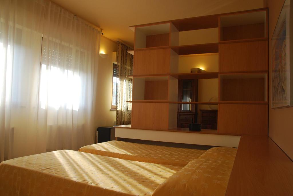 Postel nebo postele na pokoji v ubytování Nuovo Hotel Vigevano