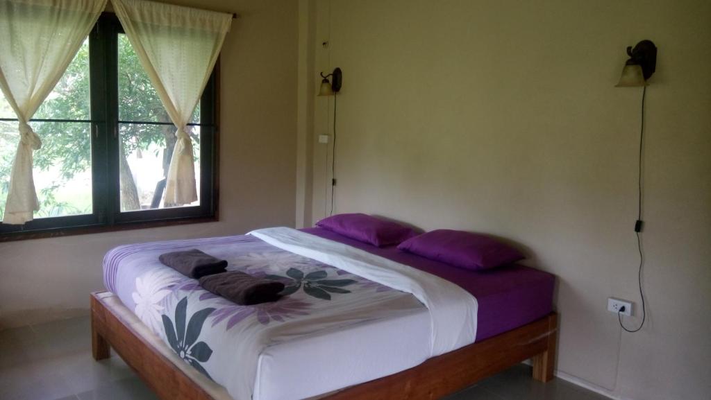 Postel nebo postele na pokoji v ubytování Ing Doi Guest House