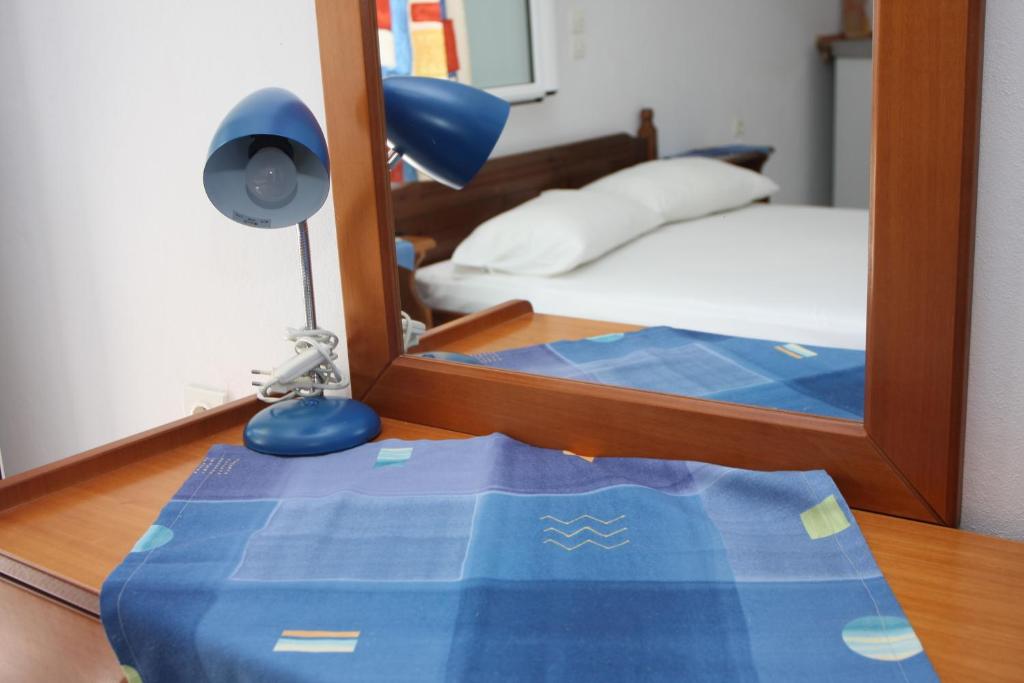 A bed or beds in a room at Akrogiali Hotel