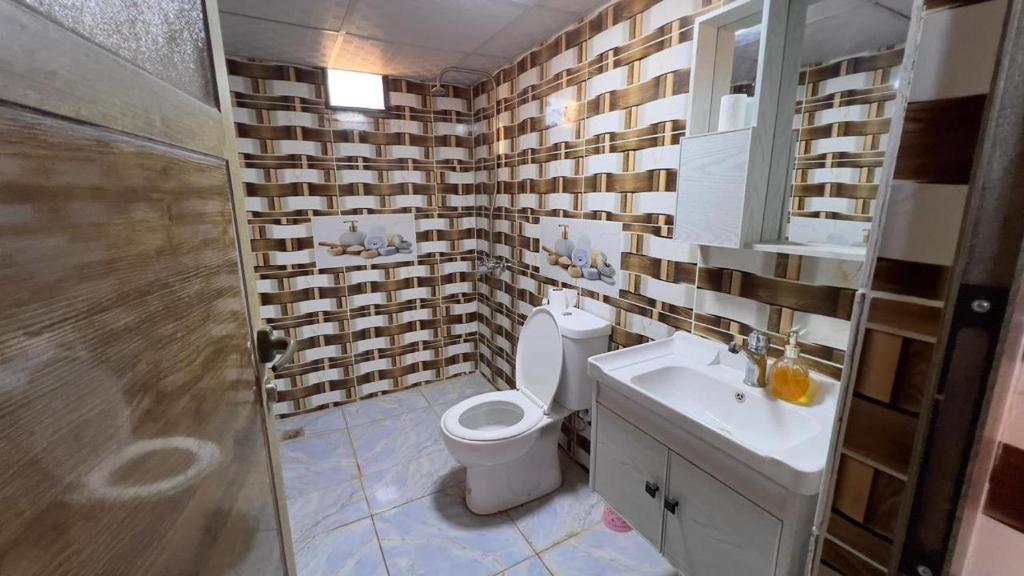 a bathroom with a toilet and a sink and a shower at Rotana camp in Disah