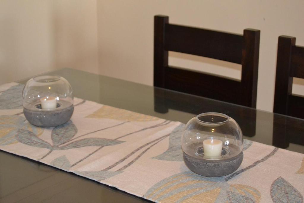 two candles in glass bowls on a table at Casa José in La Herradura