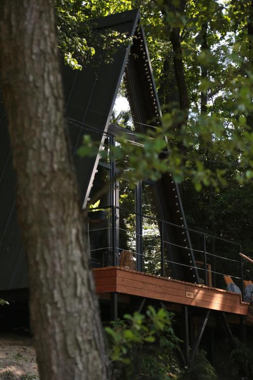 a tree house in the middle of a forest at Характер парк in Hatne