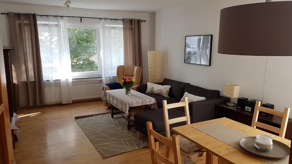 a living room with a couch and a table at Köster Apartment in Olpe