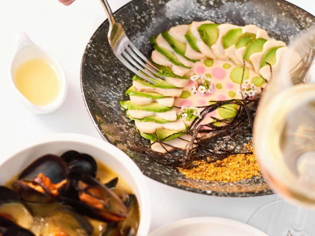 een tafel met twee borden eten en een kom soep bij Pullman Vina del Mar San Martin in Viña del Mar