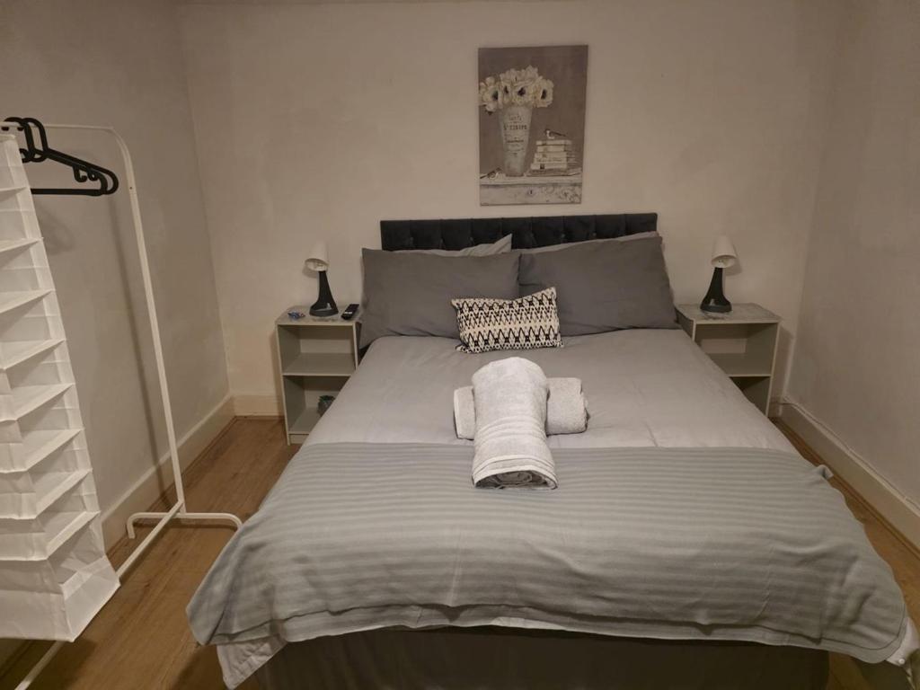 ein Schlafzimmer mit einem großen Bett, auf dem Handtücher liegen in der Unterkunft Shalom Stay Tottenham in London