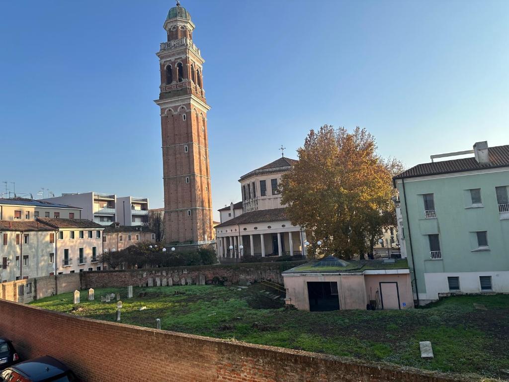 a tall clock tower in a city with buildings at residence palladio in Rovigo