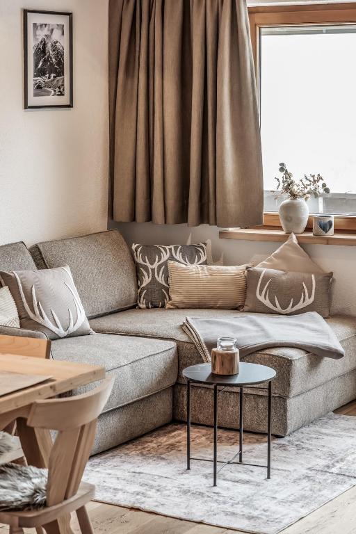 a living room with a couch and a table at Benglerwald Lodge in Bach