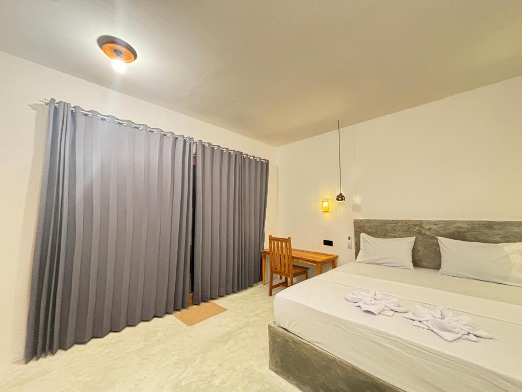 En eller flere senge i et værelse på Mengalung house