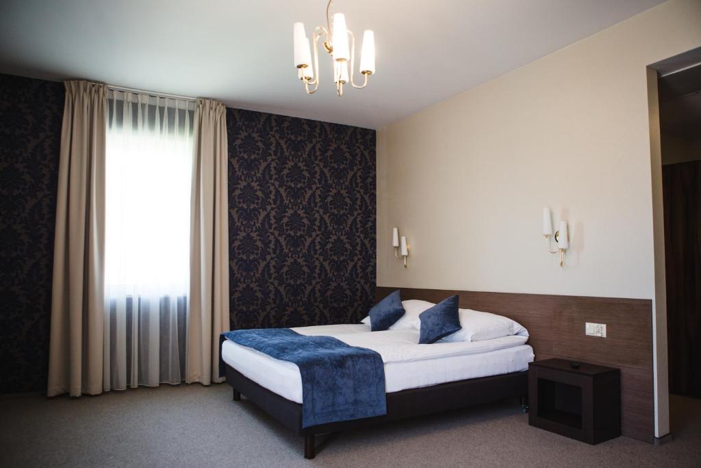 Posteľ alebo postele v izbe v ubytovaní Hotel Cztery Pory Roku