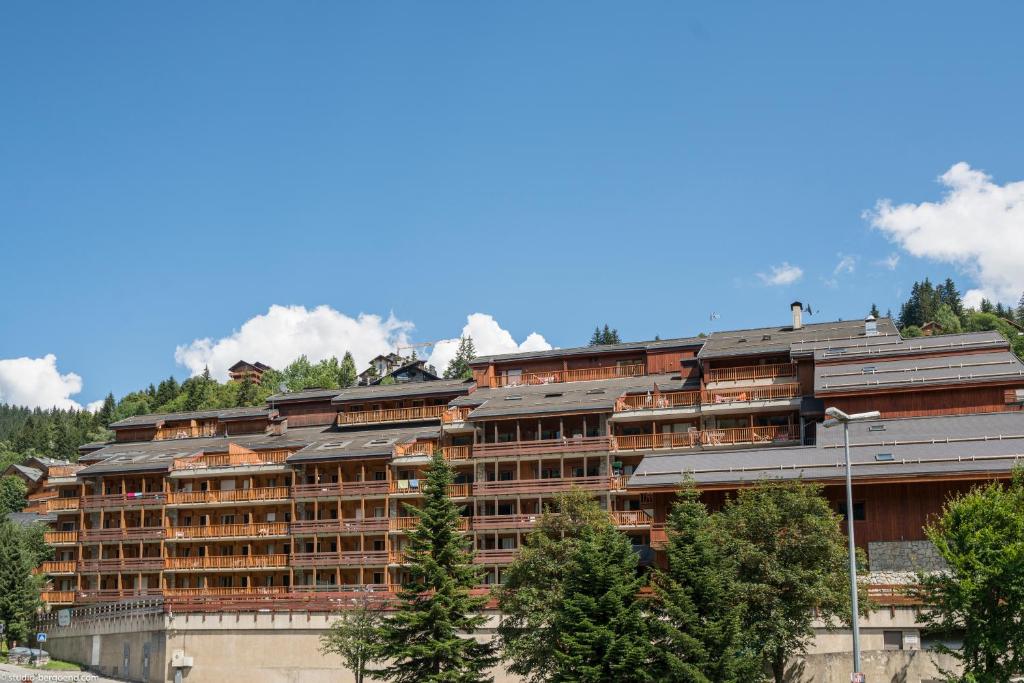 a large building with trees in front of it at R&eacute;sidence Pierre & Vacances Les Ravines in M&eacute;ribel