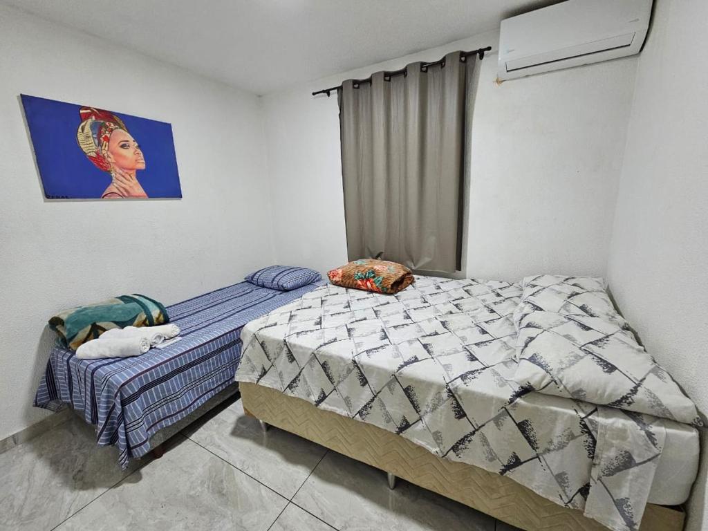 En eller flere senge i et værelse på M 446 Apartamento mobiliado com vaga de garagem