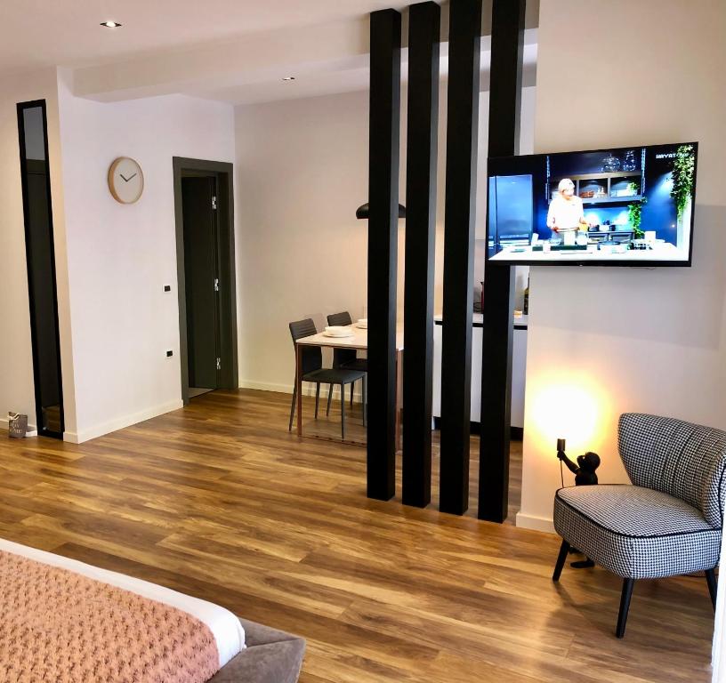 a living room with a tv and a table with chairs at Skanderbeg Center Apartments 1 in Tirana