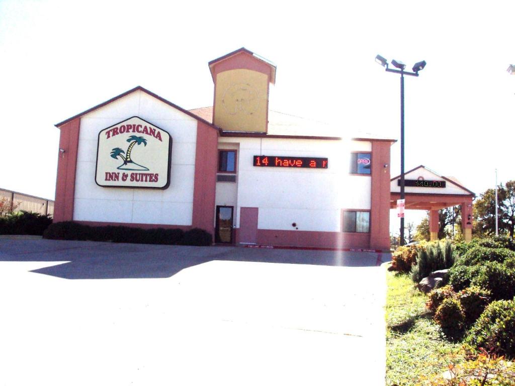 a building with a sign for a tim hortons at Tropicana Inn and Suites in Dallas