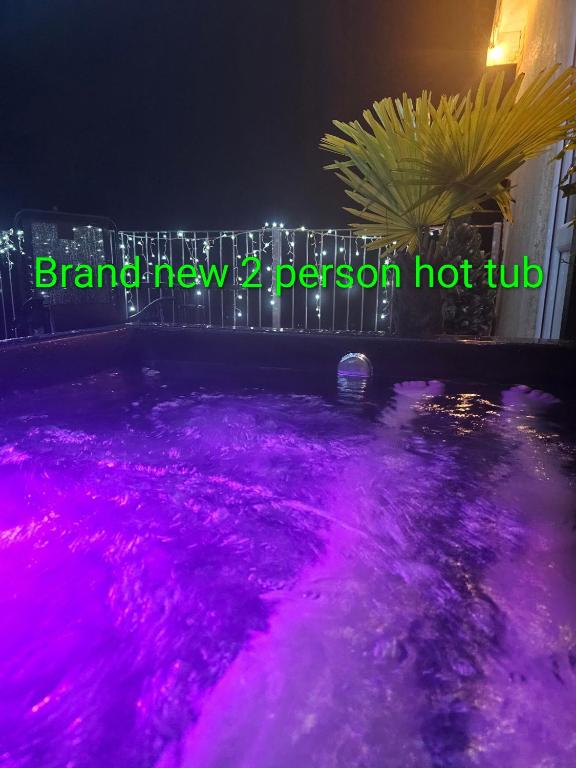 a swimming pool with pink lights on it at Rock Ridge Villa in Abertillery