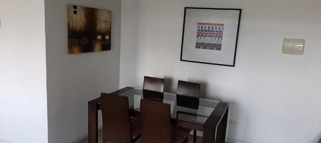 a dining room with a table and four chairs at A pasos de Ruta Cinco y Universidad in Talca